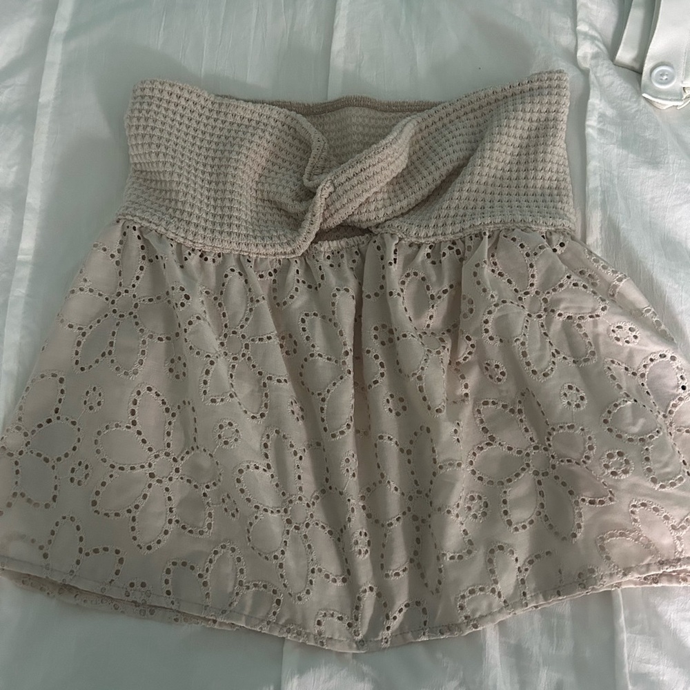 Cream mini bubble crop top with tie front and smocked design for casual wear